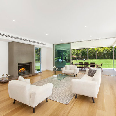 Example of a large minimalist open concept and formal light wood floor living room design in Central Coast with a standard fireplace and white walls