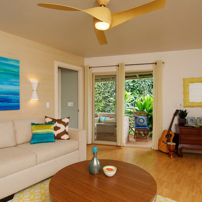 Living room - tropical medium tone wood floor living room idea in Los Angeles with beige walls