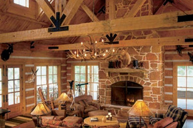Inspiration for a large rustic open concept light wood floor living room remodel in Dallas with brown walls, a two-sided fireplace and a stone fireplace