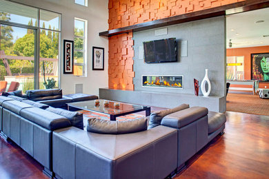 Photo of a medium sized contemporary formal open plan living room in Orange County with beige walls, dark hardwood flooring, a two-sided fireplace, a tiled fireplace surround and a wall mounted tv.