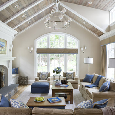 Example of a large classic enclosed vaulted ceiling living room design in DC Metro with beige walls, a standard fireplace and a stone fireplace