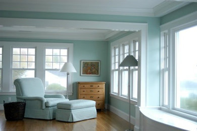 Example of a mid-sized classic open concept plywood floor and brown floor living room design in Boston with green walls