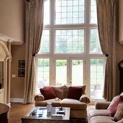 Inspiration for a large timeless open concept medium tone wood floor living room remodel in Other with beige walls