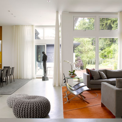 Inspiration for a contemporary open concept concrete floor living room remodel in Seattle with white walls