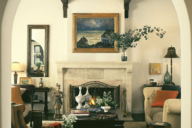 Tuscan living room photo in Los Angeles with a stone fireplace