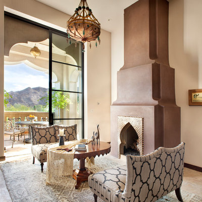 Living room - mediterranean living room idea in Other with beige walls and a standard fireplace
