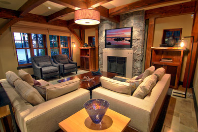 Example of a mid-sized trendy enclosed living room design in Sacramento with beige walls, a standard fireplace, a stone fireplace and a media wall
