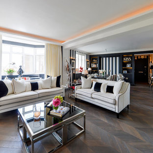Photo of an eclectic formal open plan living room in London with white walls, dark hardwood flooring and brown floors.