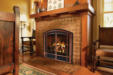 Inspiration for a medium sized traditional formal enclosed living room in Portland Maine with a standard fireplace, no tv, beige floors, yellow walls, medium hardwood flooring and a tiled fireplace surround.