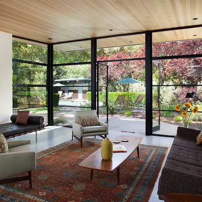 Example of a trendy formal and open concept concrete floor living room design in San Francisco with white walls