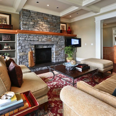 Living room - mid-sized traditional open concept dark wood floor living room idea in Seattle with beige walls, a standard fireplace, a stone fireplace and a wall-mounted tv