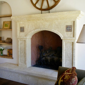 Mexican style hand-carved fireplace with a raised hearth.