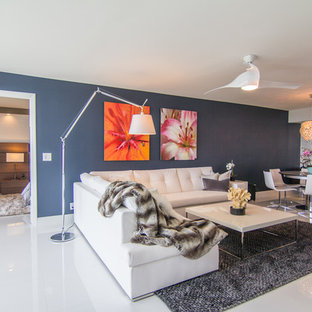 Example of a trendy open concept living room design in Newark with blue walls