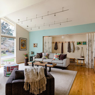 Inspiration for a small 1950s medium tone wood floor and brown floor living room remodel in Seattle with blue walls