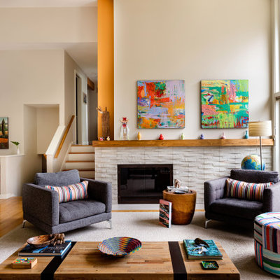 Mid-sized trendy open concept medium tone wood floor and brown floor living room photo in Seattle with a standard fireplace, a stone fireplace, no tv and beige walls