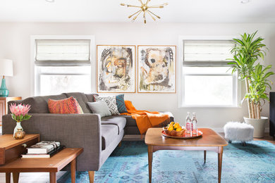 Inspiration for a mid-sized mid-century modern enclosed living room remodel in Austin with gray walls and no fireplace