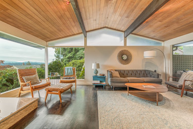 Example of a 1960s open concept dark wood floor living room design in Seattle with white walls