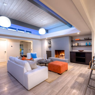 Living room - mid-sized 1950s open concept light wood floor living room idea in San Francisco with white walls, a standard fireplace and a plaster fireplace