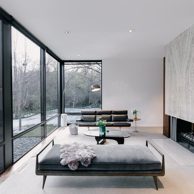 Example of a large minimalist open concept carpeted living room design in Salt Lake City with white walls, a two-sided fireplace, a stone fireplace and no tv