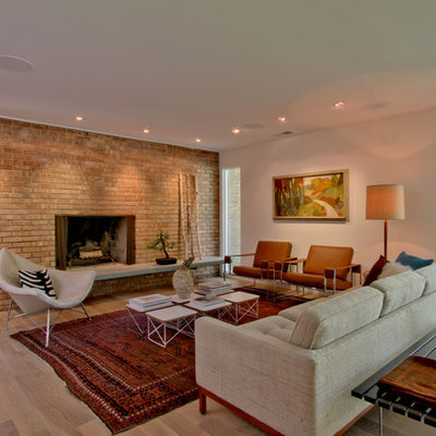 Inspiration for a mid-sized 1950s open concept and formal light wood floor and beige floor living room remodel in Indianapolis with white walls, a standard fireplace, a brick fireplace and no tv