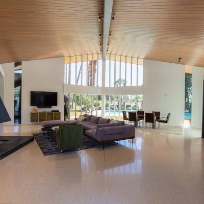 Large 1960s open concept white floor and vaulted ceiling living room photo in Other with a bar, white walls, a standard fireplace, a metal fireplace and a wall-mounted tv