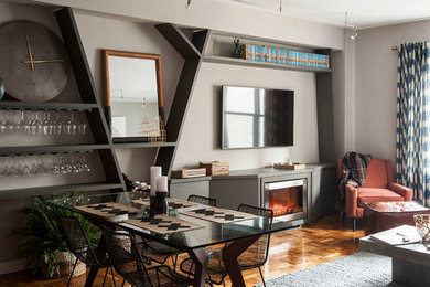 Example of a mid-sized trendy open concept medium tone wood floor living room design in New York with gray walls, a wall-mounted tv, a ribbon fireplace and a metal fireplace