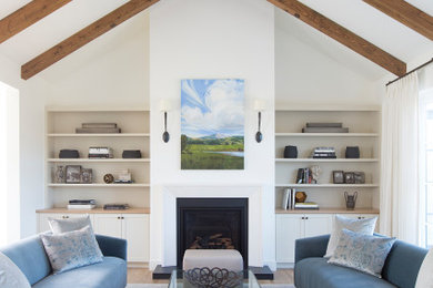 Inspiration for a mid-sized farmhouse open concept light wood floor, brown floor and vaulted ceiling living room remodel in San Francisco with white walls, a standard fireplace, a stone fireplace and no tv