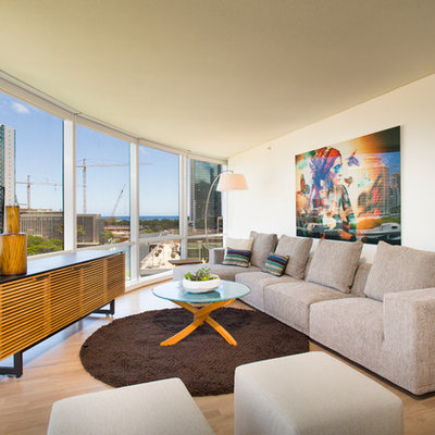 Trendy open concept medium tone wood floor living room photo in Hawaii with white walls and no fireplace