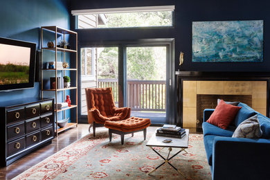 Large eclectic formal and enclosed medium tone wood floor living room photo in San Francisco with blue walls, a standard fireplace, a wall-mounted tv and a tile fireplace