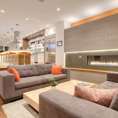 Trendy formal and open concept medium tone wood floor living room photo in Calgary with white walls, a ribbon fireplace and no tv
