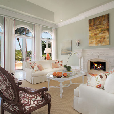 Large trendy formal and open concept ceramic tile and beige floor living room photo in Miami with gray walls, a standard fireplace, a stone fireplace and no tv