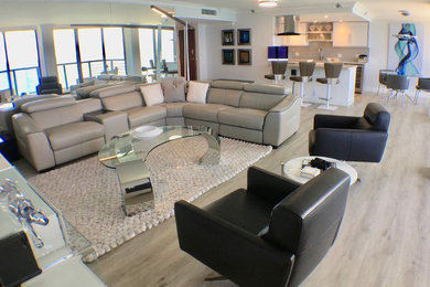 Example of a mid-sized minimalist open concept laminate floor and gray floor living room design in Miami with gray walls, no fireplace and a wall-mounted tv