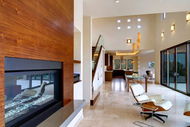 Imagen de salón abierto moderno grande con paredes blancas, suelo de travertino, todas las chimeneas, marco de chimenea de madera y suelo beige