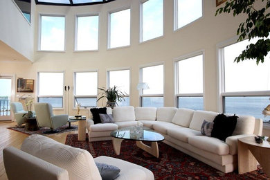 Living room - huge modern open concept light wood floor living room idea in New York with beige walls