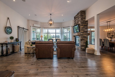 Living room - large contemporary open concept medium tone wood floor living room idea in Other with white walls, a two-sided fireplace and a stone fireplace