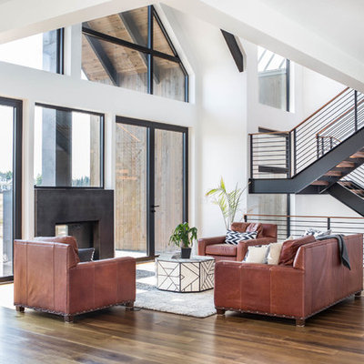 Large trendy open concept medium tone wood floor and brown floor living room photo in Seattle with white walls, a two-sided fireplace, a concrete fireplace and no tv