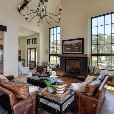 Inspiration for a transitional open concept medium tone wood floor living room remodel in Sacramento with white walls, a standard fireplace and no tv