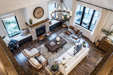 Living room - large cottage open concept dark wood floor living room idea in Other with white walls, a standard fireplace, a stone fireplace and no tv