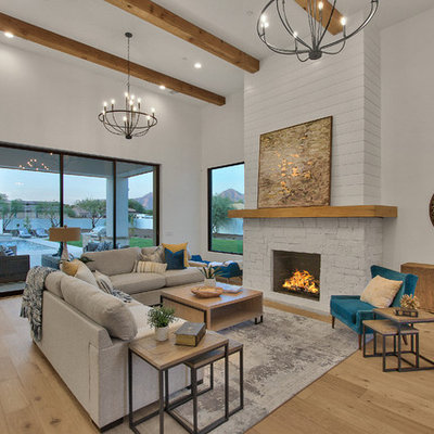 Inspiration for a farmhouse open concept light wood floor and beige floor living room remodel in Phoenix with white walls, a standard fireplace and a stone fireplace