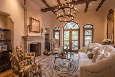 Living room - large mediterranean formal and enclosed medium tone wood floor living room idea in Phoenix with beige walls, a standard fireplace, no tv and a stone fireplace