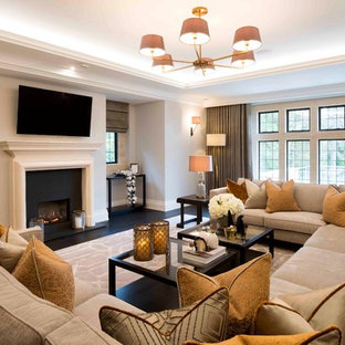 This is an example of a medium sized classic living room in West Midlands with beige walls and black floors.