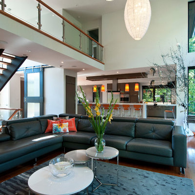 Living room - mid-sized contemporary formal and open concept medium tone wood floor living room idea in Toronto with beige walls, a ribbon fireplace, a stone fireplace and no tv
