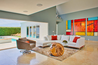 Example of a large minimalist open concept living room design in Orange County with blue walls and no fireplace