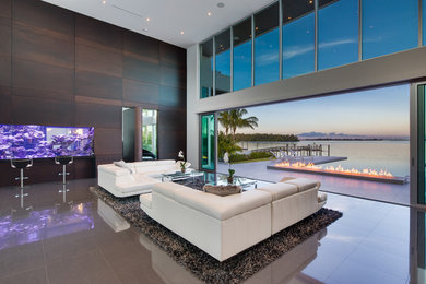 This is an example of a contemporary open plan living room in Miami with marble flooring.
