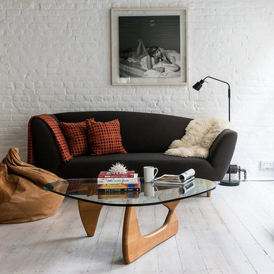 Example of an urban formal and open concept light wood floor living room design in London with white walls and a tv stand