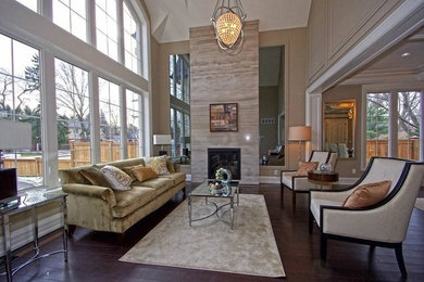 Inspiration for a mid-sized transitional formal and open concept dark wood floor and brown floor living room remodel in Toronto with beige walls, a standard fireplace, a stone fireplace and no tv