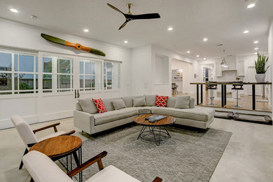 Example of a large minimalist open concept beige floor living room design in Houston with white walls, a standard fireplace, a concrete fireplace and a wall-mounted tv