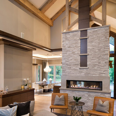 Example of a trendy open concept living room design in Minneapolis with a two-sided fireplace