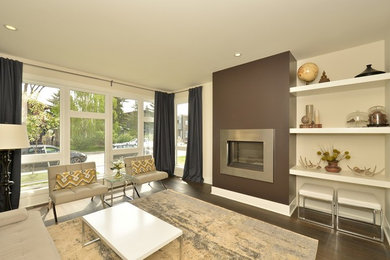 Example of a mid-sized minimalist enclosed dark wood floor living room design in Edmonton with white walls and a standard fireplace