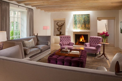Inspiration for a mid-sized eclectic enclosed light wood floor living room remodel in Phoenix with white walls, a standard fireplace and a stone fireplace
